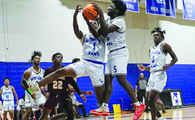 Interlachen’s Justin Herring (1) and Reggie Allen Jr. fight for a rebound in front of Crescent City’s Freddie Major during the teams’ Dec. 2 meeting at Interlachen won by the Rams, 71-39. (RITA FULLERTON / Special to the Daily News)
