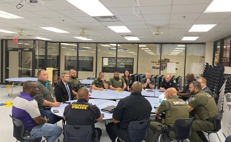 Putnam County sheriff's deputies and Palatka police officers, along with Putnam County School District representatives, discuss strategy amid a surge in juvenile violence this spring. Photo courtesy of the Palatka Police Department.