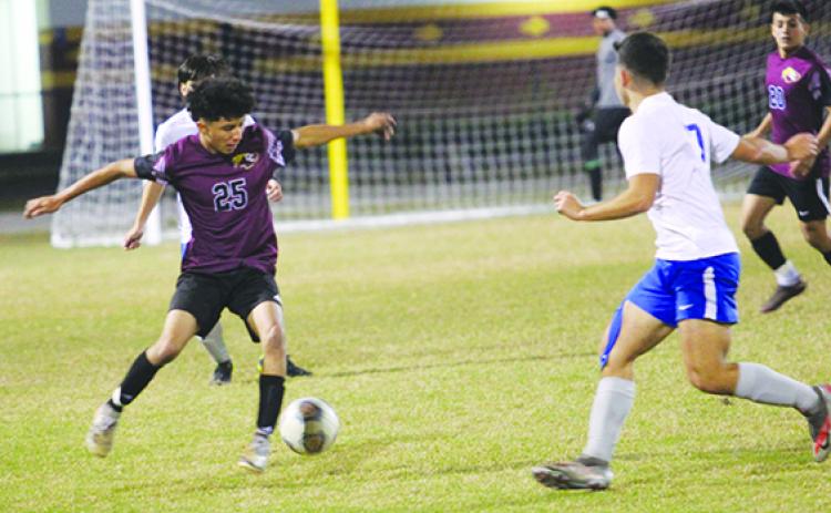 Crescent City’s Anthony Vazquez gets control of the ball in the backfield, while Deltona’s Alex Soto attacks during the first half Tuesday night. (MARK BLUMENTHAL / Palatka Daily News)