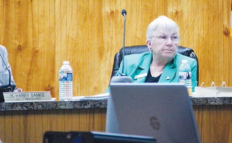 Crescent City Commissioner Cynthia Burton listens to a member of the public speak during a commission meeting Thursday evening.