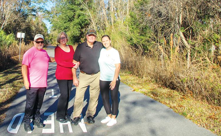 Life Distance 5K and Etoniah Gravel & Social Rides Director Kraig McLane, left, stands on the trails at Coventry Oaks Farms with the Coventry Oaks owners, Claudia and Jeff Barnes, and Visit Palatka Event Coordinator Stephanie Reems.