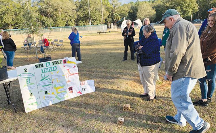 Attendees of Pomona Park’s Arbor Day celebration play a game of Win a Tree Trivia at Hazen Ball Field last Friday. More Arbor Day festivities are planned throughout the county beginning Friday.