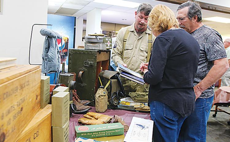 World War II reenactor Thomas Philyaw shows One Book One Putnam participants some of his collection Thursday at the kickoff event for the annual reading initiative.