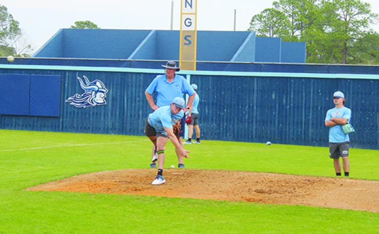 Freshman Payton Waters throws a pitch in practice in front of St. Johns River State College baseball coach Ross Jones as sophomore and former Palatka High standout Layton DeLoach watches. (MARK BLUMENTHAL / Palatka Daily News)