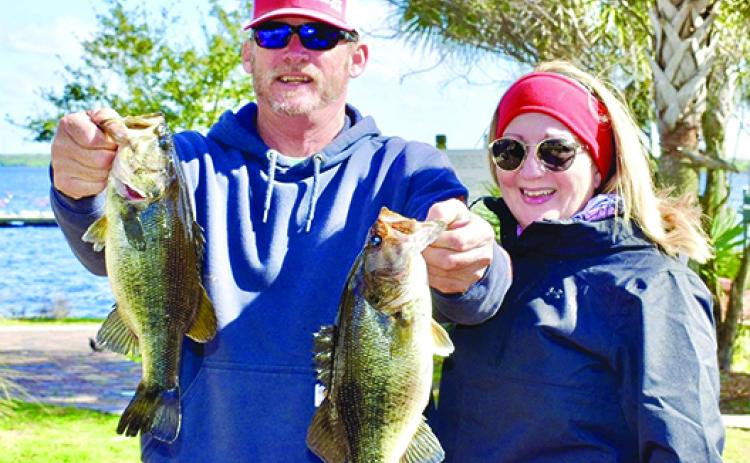 Wayne and Karen Martin of Palatka, regulars on many of the local bass tournaments, show off their bass to the scales in Saturday’s Messer’s Invitational Bass Tournament. (GREG WALKER / Daily News correspondent)