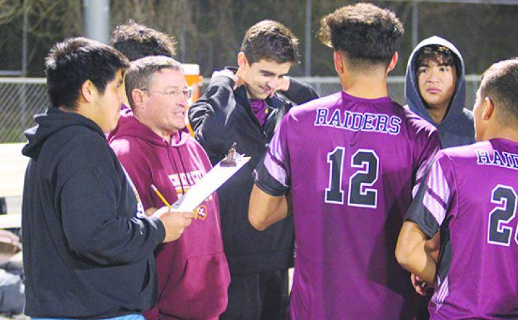 Crescent City boys soccer coach Jeff Lease (second, left) and his Raiders advanced to the Region 3-3A semifinals after defeating Melbourne West Shore, 3-1, Wednesday night. (MARK BLUMENTHAL / Palatka Daily News)