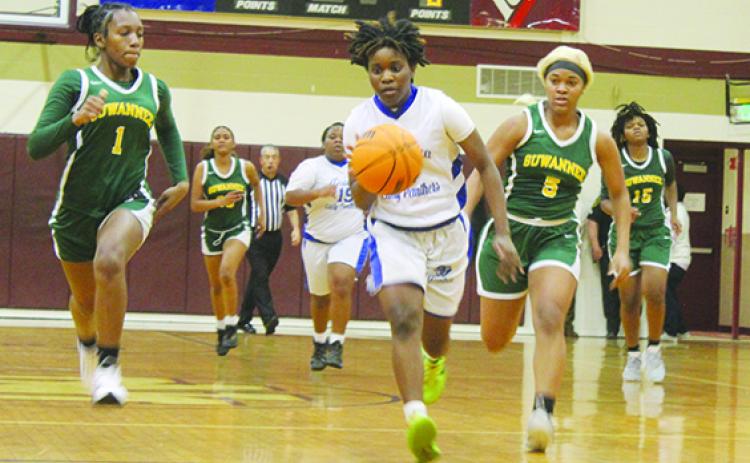 Palatka’s Zy’ria Jones drives to the basket on a fastbreak with Live Oak Suwannee’s Janeah Mitchell (1) and Amyah Jones (5) during the third quarter of Thursday’s District 5-4A tournament semifinal at North Marion High School. (MARK BLUMENTHAL / Palatka Daily News)