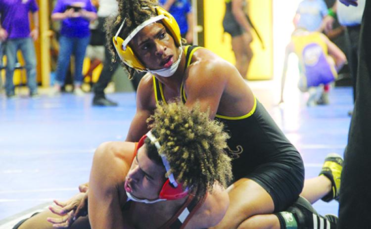 Palatka’s Ishmael Foster holds down Tocoi Creek’s Willie Sims during his 132-pound semifinal match, which Foster won, 17-7. (COREY DAVIS / Palatka Daily News)