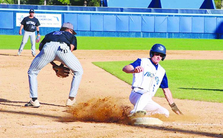 St. Johns River State College’s Michael Furry slides safely into third base as Daytona State third baseman Devon Nowles retrieves the ball during the third inning of Wednesday’s game at Tindall Field. (RITA FULLERTON / Special to the Daily News)