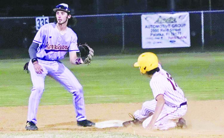 Crescent City’s Cayde Morris slides safely into second base as Lake Weir shortstop Garrett Payne awaits the throw. (RITA FULLERTON / Special to the Daily News)
