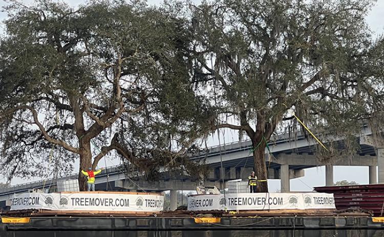 A barge is seen floating down the St. Johns River under the Memorial Bridge on Saturday.