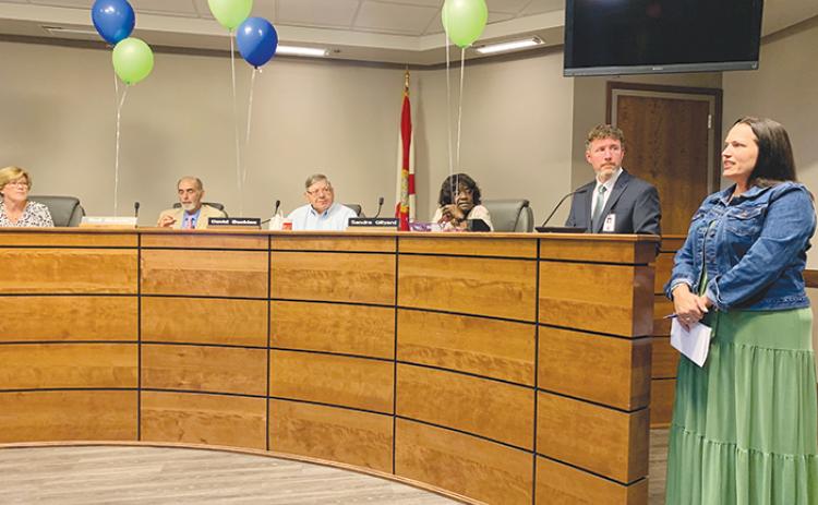 School district spokeswoman Ashley McCool, far right, addresses the school board in 2021.