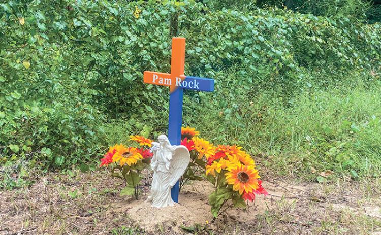 A memorial to Pamela Rock sits in an Interlachen neighborhood where she was fatally attacked by dogs while she was delivering mail in August 2022. The memorial is still standing.