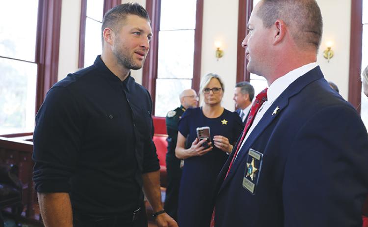 Former NFL quarterback Tim Tebow, left, talks with Putnam County Sheriff Gator DeLoach during a press conference Thursday morning.