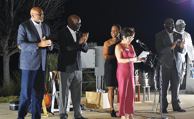 Mayor Robbi Correa addresses the crowd during the Mayor’s Reception on Friday at the Palatka riverfront while, from left to right, City Commissioners Will Jones, Rufus Borom, Tammie McCaskill and Justin Campbell listen. 