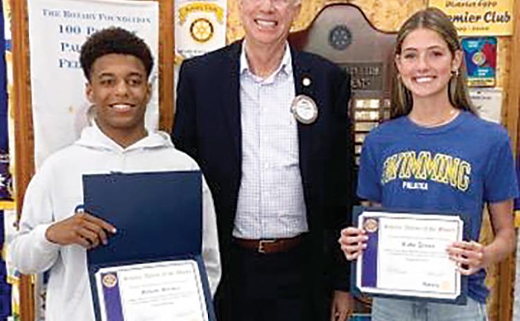 Palatka Junior-Senior High School senior Mikade Harvey, left, Rotarian Robert Mills, center, and senior Ruby Doran gather for a photo after the Rotary Club of Palatka honored the students for their efforts in academics and athletics.