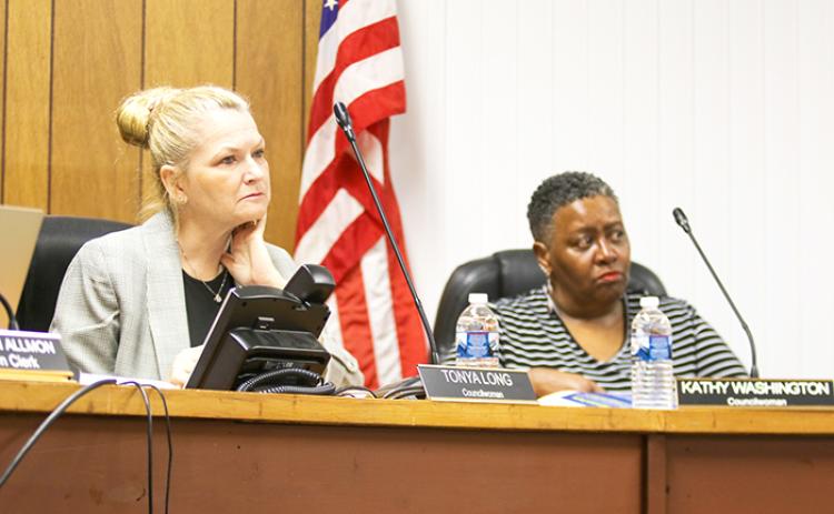 Tonya Long, left, listens to a discussion at a Welaka Town Council meeting