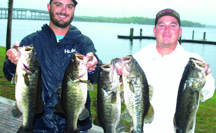 San Mateo’s Avery Romero and St. Augustine’s Dillon Drury hold up their winning fish at the Palatka City Dock Saturday. (GREG WALKER / Daily News correspondent)