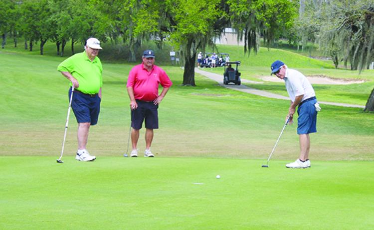 Fred Peel of Chipley putts on the ninth hole as Palatka’s Ronnie Tumlin (left) and Kevin Durscher watch in Friday’s opening round. (MARK BLUMENTHAL / Palatka Daily News)