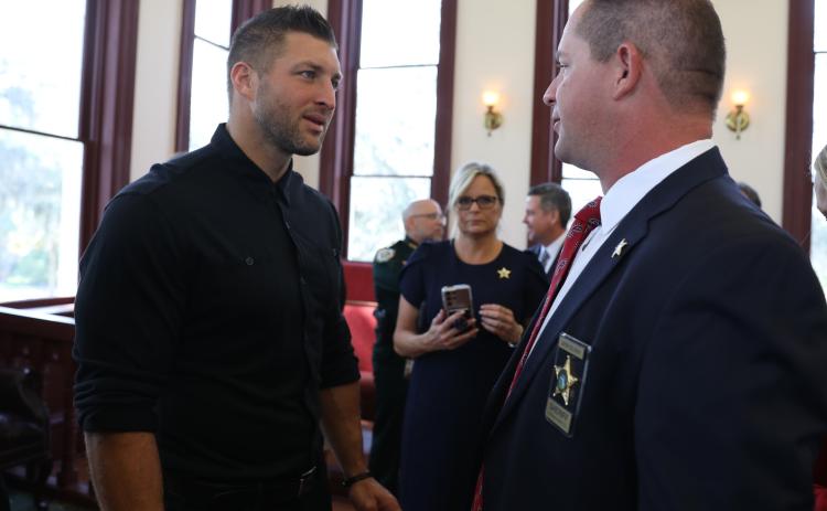 Courtesy of the Putnam County Sheriff's Office. Putnam County Sheriff Gator DeLoach talks to former University of Florida football player Tim Tebow during a press conference about the Florida Inter-Agency Child Exploitation and Person Trafficking Task Force.