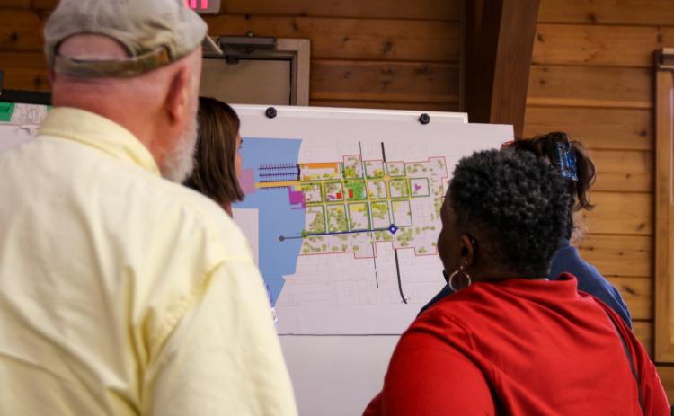 SARAH CAVACINI/Palatka Daily News. Residents and stakeholders look over a map Tuesday night of Welaka where some developments are suggested to be implemented as part of a new vision for the town.  