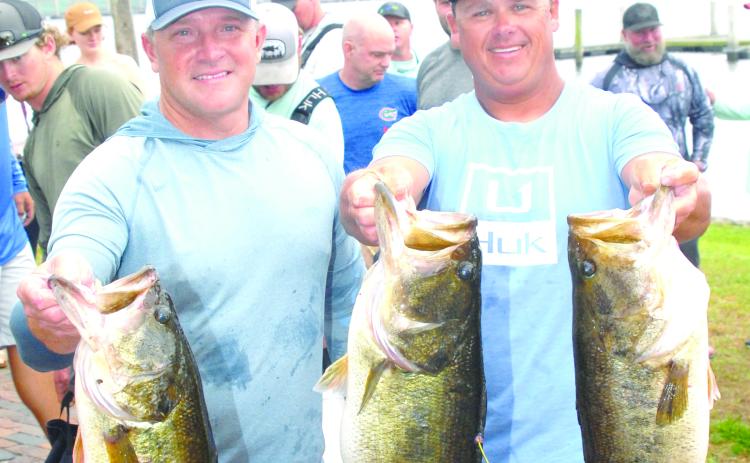 Jason Caldwell and Lee Stalvey show their three 9-pound largemouth bass that led to their win in the Roberts-Williams Invitational Bass Tournament on Saturday and Sunday at Palatka City Dock. (GREG WALKER / Daily News correspondent)