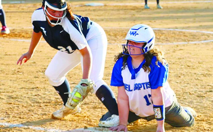 Peniel Baptist Academy’s Nevaeh Escoffier (17) gets back into first base safely ahead of a pickoff attempt by St. Johns Country Day first baseman Anna Kemp during Friday’s game at Rotary Park. (RITA FULLERTON / Special to the Daily News)