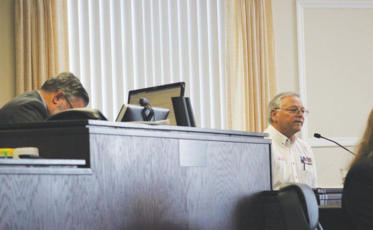 Supervisor of Elections Charles Overturf III, right, testifies while Judge Kenneth Janesk, left, takes notes during a hearing in the effort to recall Crescent City Commissioner Cynthia Burton.