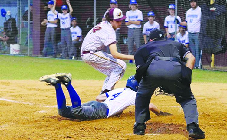Peniel Baptist Academy’s Nick Fisher scores on a wild pitch as Crescent City pitcher D.J. Hullett gets to the plate to try and get the throw. (RITA FULLERTON / Special to the Daily News) 