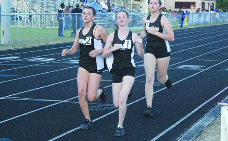 Interlachen’s Paislee Guessford, Myah Vinson and Erin Jacobsen have been strong competitors in the 3,200 this season. (MARK BLUMENTHAL / Palatka Daily News)