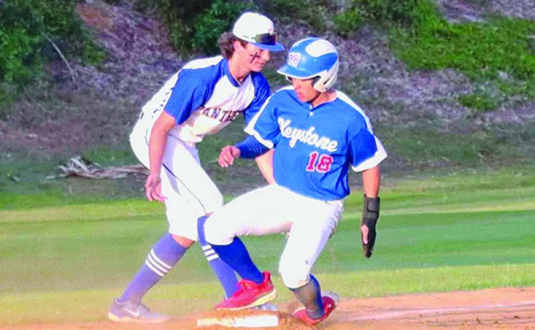 Keystone Heights’ Aiden Screen (18) gets into third base safely as Palatka third baseman Jace Akers looks to get the tag on him during Tuesday’s game at the Azalea Bowl. (RITA FULLERTON / Special to the Daily News)