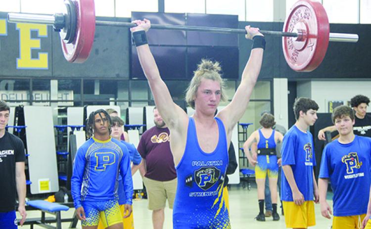 With teammate Ishmael Foster watching behind him, Palatka 154-pounder Braxton Anderson competes in the clean and jerk at the Putnam County Championship meet in February. Foster and Anderson are two of the county’s five competitors at Saturday’s FHSAA 1A championship. (COREY DAVIS / Palatka Daily News)