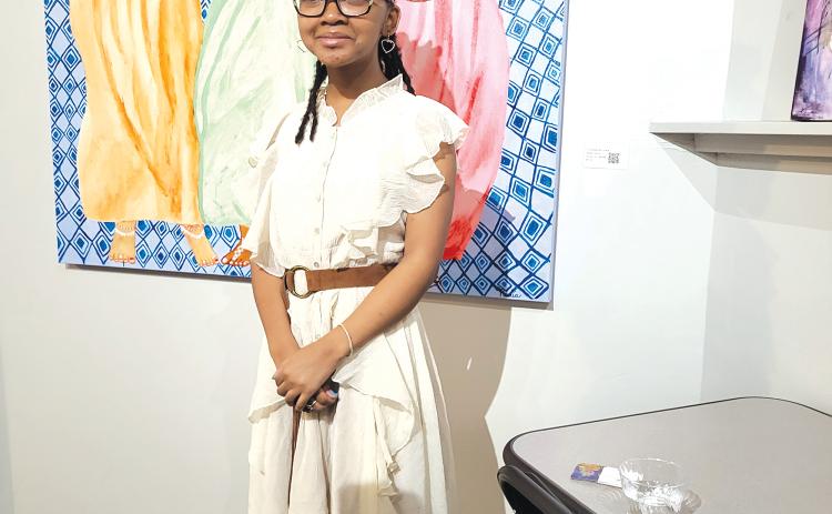 Nadia Harris, 13, is pictured with some of her acrylic paint canvas art.  (Photo courtesy of Yolanda Harris)