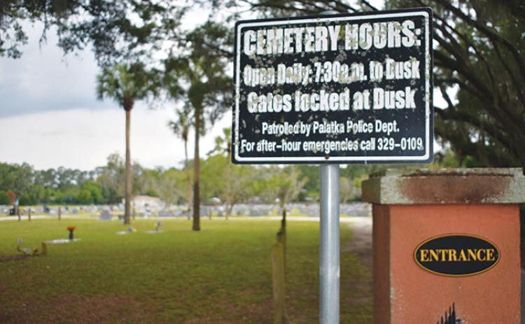 A sign is posted in front of Oak Hill West Cemetery in Palatka to inform people the facility’s gates are locked from dusk until 7:30 a.m.