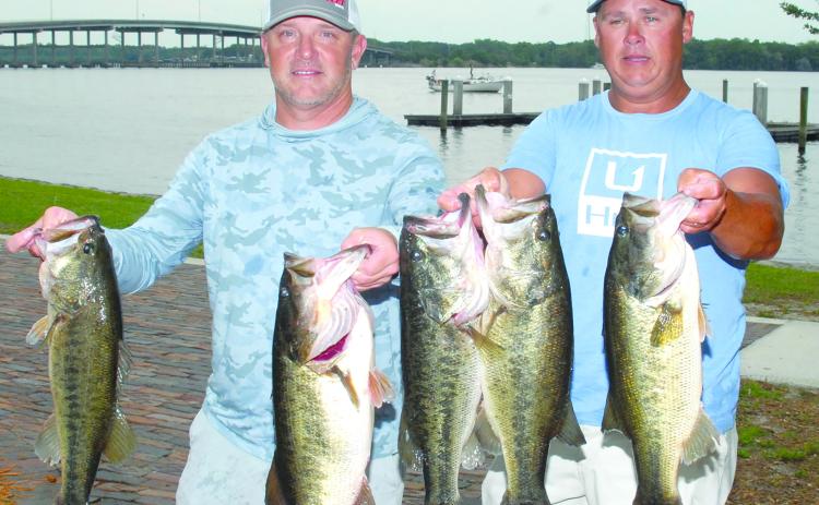 Jason Caldwell and Lee Stalvey hold up their winning fish at the Messer’s Invitational Bass Tournament at Palatka, (GREG WALKER / Daily News correspondent)