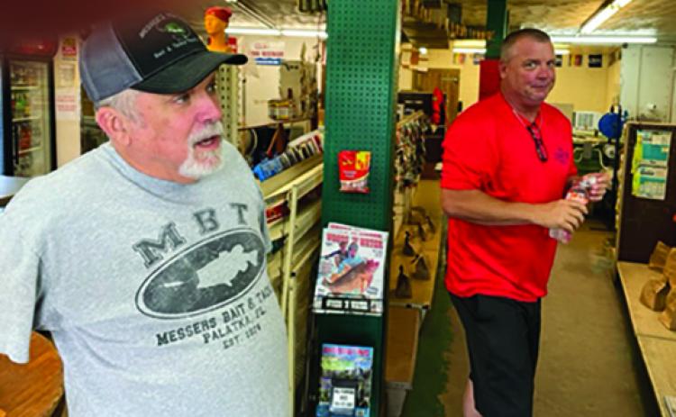 Messer’s Westside Bait & Tackle manager Jimmy Darby (left) engages in conversation with store customer Curtis Aleshire Friday morning. (MARK BLUMENTHAL / Palatka Daily News)
