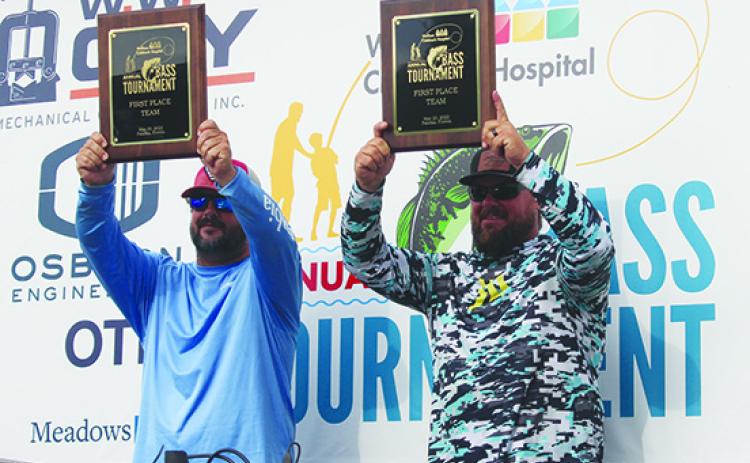 Daniel Robertson (left) and Steven Keith show off their first-place plaques after winning Saturday’s Wolfson Children’s Hospital Bass Tournament. (MARK BLUMENTHAL / Palatka Daily News)