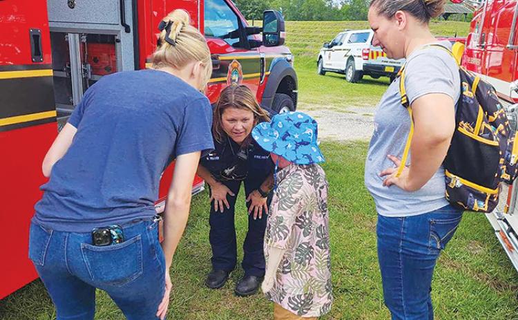 Nathan Scott, 6, talks with paramedic Monica Weaver, who was also on duty in December when the child had to be rushed to a hospital.