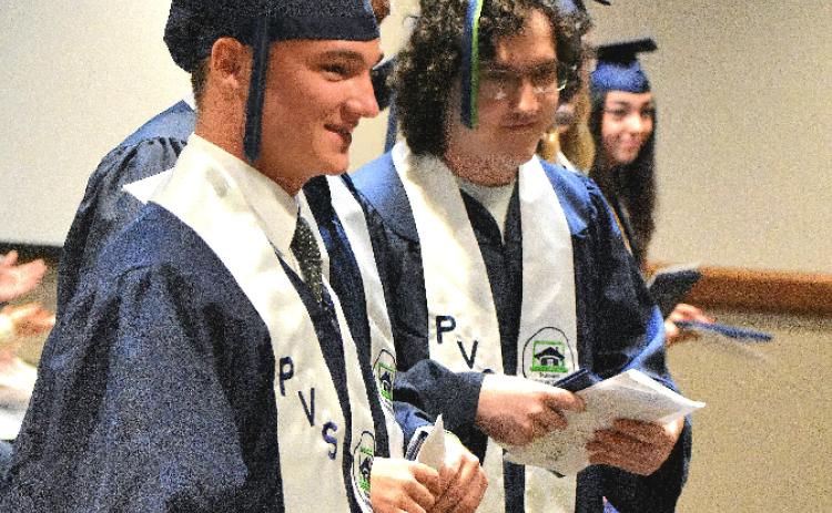 Putnam Virtual School graduates stand together after having turned their tassels during their commencement ceremony Monday.