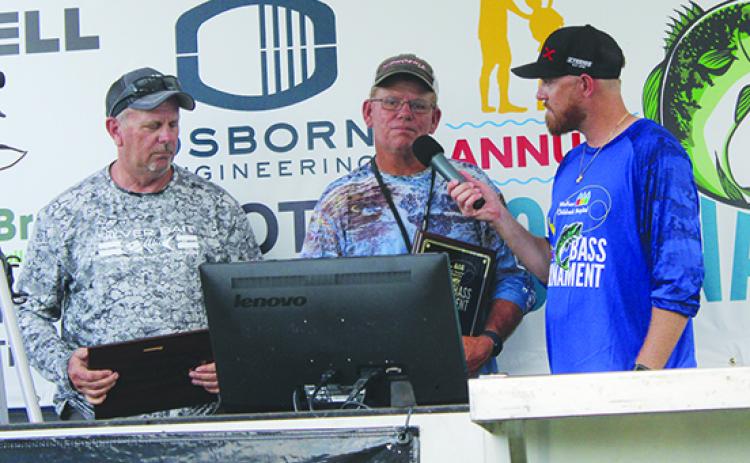 Randy Sievert (left) and fishing partner Danny Inabnett are interviewed by tournament host Brian Stahl after winning the Lads & Lasses Tournament. (MARK BLUMENTHAL / Palatka Daily News)