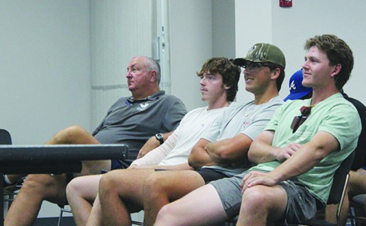 St. Johns River State College baseball coach Ross Jones (left) and team players Paddy Smith, Tanner Walker and Jack Clarke wait to find out where the Vikings are seeded for the NJCAA Division II College World Series. (MARK BLUMENTHAL / Palatka Daily News)
