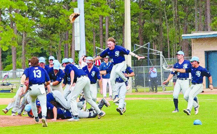 St. Johns River State College baseball players celebrate moments after the final out Saturday in a 6-4 victory over Lenoir Community College of North Carolina. (RITA FULLERTON / Special to the Daily News)