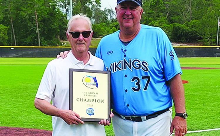 St. Johns River State College president Joe Pickens (left) and head baseball coach and athletic director Ross Jones pose with the Region 8 Division II junior college championship plaque after the Vikings defeated Palm Beach State, 2-0, in the championship game Saturday in New Port Richey. (Submitted / St. Johns River State College)
