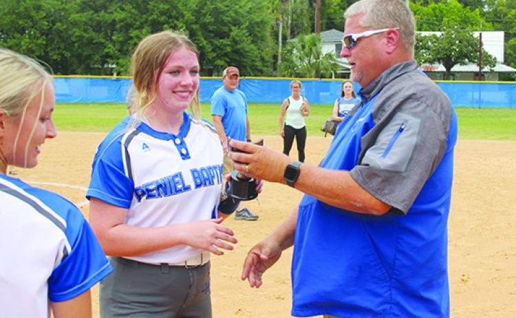 Peniel Baptist Academy's Lexi Peacock receives the Most Outstanding Player honor from head coach Jeff Hutchins after pitching and hitting the Warriors to the Florida Christian Athletic League championship Saturday at Rotary Park against Gainesville Countryside Christian, 10-0. (MARK BLUMENTHAL / Palatka Daily News)