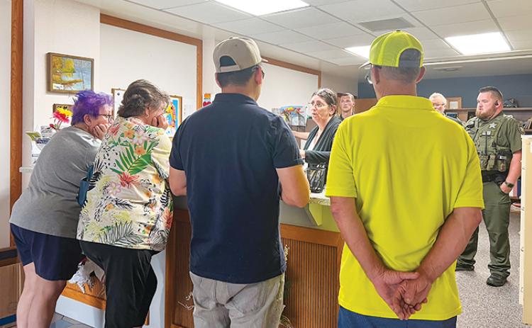 SARAH CAVACINI/Palatka Daily News. Four of the five people who filed petitions to recall Crescent City Mayor Michele Myers and Commissioner Cynthia Burton stand in the city's administrative office around 11 a.m. Tuesday with city staff. 