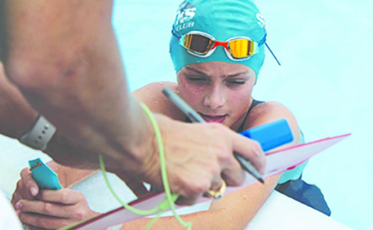 Shelby Malandrucco, here taking a break after winning a race on June 3, won three races in Saturday’s tri-meet at Eagle Harbor Swim Club. (MARK BLUMENTHAL / Palatka Daily News)