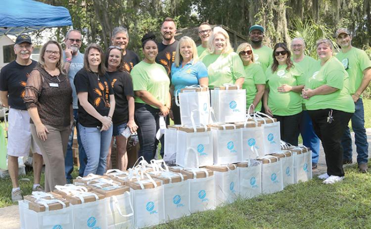 Representatives from Florida Power & Light, Suwannee River Economic Council in Palatka, United Way of St. Johns County and First Presbyterian Church of Palatka volunteer at a hurricane meal kit distribution earlier this week.