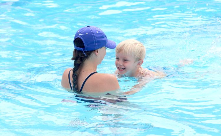 TRISHA MURPHY/Palatka Daily News. Lifeguard Haley Gill helps Blake Akers, 5, with his kicking exercise in the water during level 1 swimming lessons on Tuesday at the Putnam Aquatic Center in Palatka.