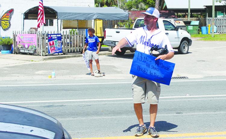 Melrose Babe Ruth 13-and-under all-star baseball coach Mark Musgrove looks for donations for his team on Saturday. (MARK BLUMENTHAL / Palatka Daily News)