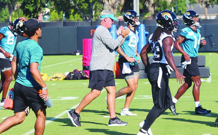 Jacksonville Jaguars head coach Doug Pederson (center) gives encouragement to his players on the first day of preseason camp at the new Miller Electric Center on Wednesday. (MARK BLUMENTHAL / Palatka Daily News)